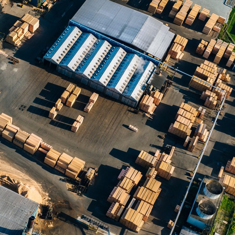 Aerial view of stacked planks in timber yard